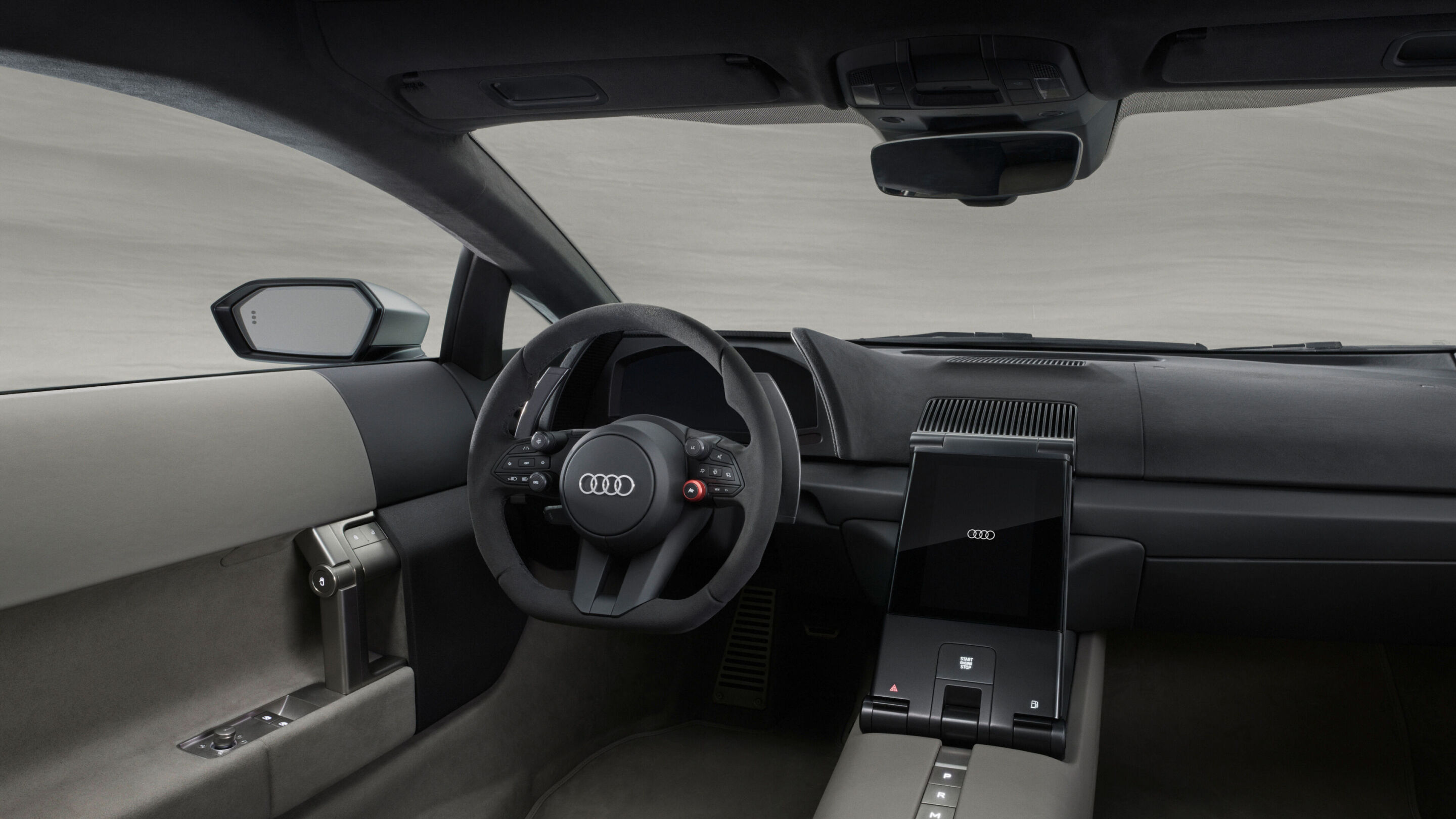 Audi Nuvolari interior — driver-centric portrait screen, chunky physical controls, Auto Union colour reference, two-tone upholstery